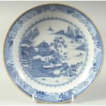 AN 18TH CENTURY CHINESE BLUE AND WHITE PORCELAIN DISH, decorated with a temple within a landscape