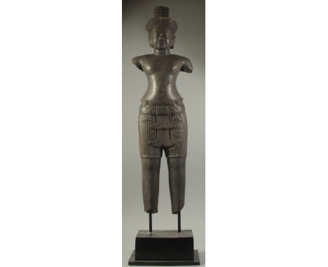 A FINE AND LARGE CAMBODIAN KHMER OR KHMER STYLE CARVED BLACK STONE FIGURE OF A MALE DEITY, raised on a wooden stand, stone 97