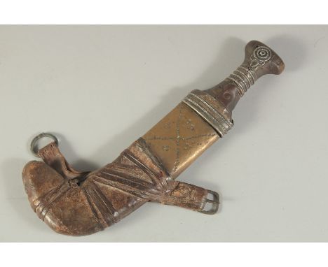 A 19TH CENTURY ARAB OMANI OR EMIRITES RHINO HORN HILTED JAMBIYA DAGGER, together with scabbard, 28cm long overall.