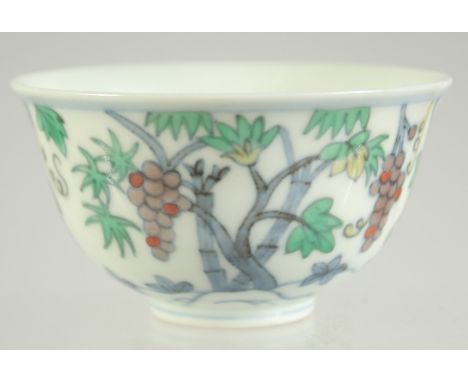 A CHINESE DOUCAI PORCELAIN CUP, decorated with fruits, base with character mark, 8cm diameter.