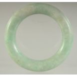 A SMALL ANTIQUE CHINESE JADEITE BANGLE, 6cm diameter.