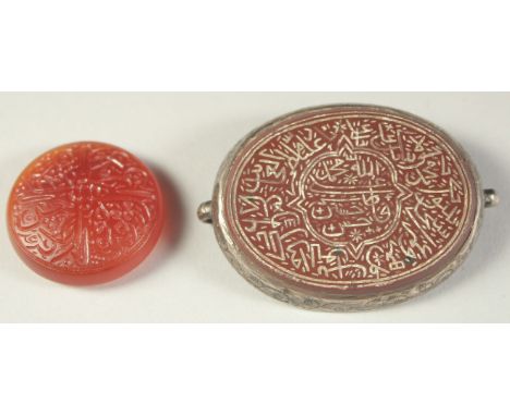 A FINE 19TH CENTURY INDIAN ENGRAVED AGATE AMULET, with silver backing, along with another engraved agate seal, (2).