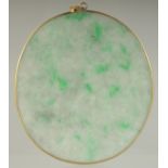 AN EARLY 20TH CENTURY JADEITE OVAL PENDANT, 6cm x 5cm.
