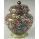 A LARGE JAPANESE BLACK GROUND CLOISONNE JAR AND COVER, with decorative floral roundels, 27cm high.