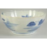 AN EARLY 20TH CENTURY JAPANESE BLUE AND WHITE PORCELAIN BOWL, the interior with landscape scene,