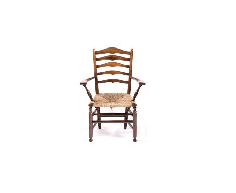 Gordon Russell (1892-1980) Armchair, circa 1920s yew wood, shaped ladder back, ring turned supports and wide set shaped arms 