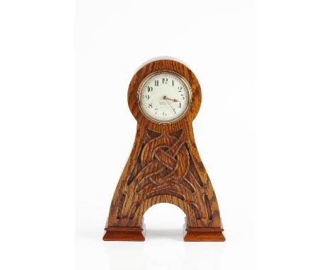 Archibald Knox (1864-1933) for Liberty &amp; Co. Arts &amp; Crafts mantle clock, circa 1900 enamel dial within oak case carve