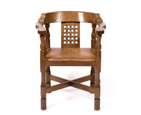 Robert Thompson of Kilburn (1876-1955)  Mouseman monk's chair oak, the curved back with woven design, above leather seat and 