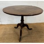 A circular oak pedestal table. Turned central support on splayed tripod legs. Diameter 83 height 70