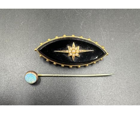 A mourning brooch and an opal lapel pin
