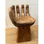 A wooden carved seat or stool in the form of a hand (H62cm)