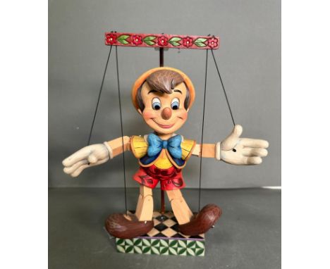 A boxed wooden Disney puppet of Pinocchio 