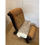 A slipper chair or nursing chair in need of recovering