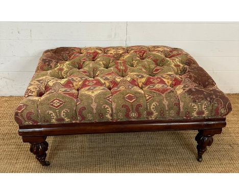 A mahogany framed ottoman or foot stool button tufted and upholstered in red and greens (H46cm W100cm D77cm)