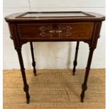 A Victorian bijouterie table with string and scrolling floral inlay on turned legs and castors