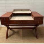 A brown leather campaign style writing desk, one long central drawer flanked by two shorter drawers,