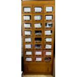 A light oak haberdashery cabinet comprising of twenty four short drawer and one long drawer under (