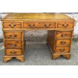 A green leather topped pedestal desk (H79cm W120cm D60cm)