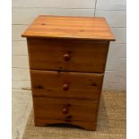 A pine three drawer bedside (H67cm SQ48cm)