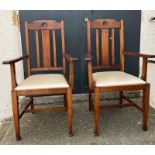A pair of oak Arts and Crafts style arm chairs with drop in seats Circa 1905