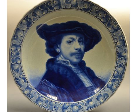 A large Delft charger, painted portrait of Rembrandt, impressed marks.