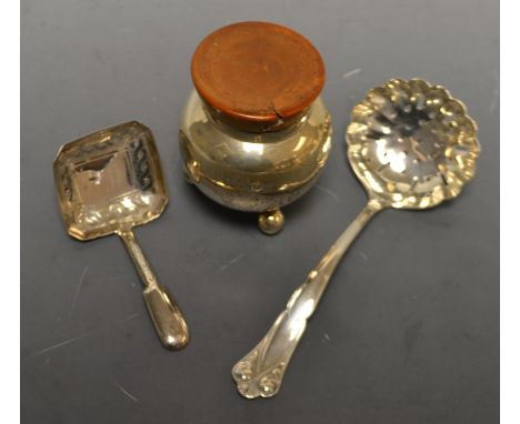 A pierced silver sifter spoon; a silver caddy spoon; a silver globular pot, resting on three spherical feet, hardwood cover (
