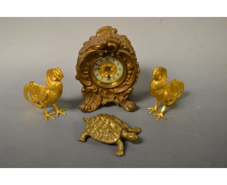 A gilt brass clock; a pair of gilt brass cockrels; a brass model tortoise (4)