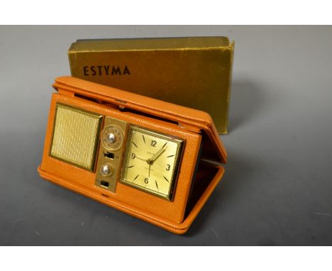 A retro 1950s/60s Estyma travelling radio alarm clock, tan leather case, original card box