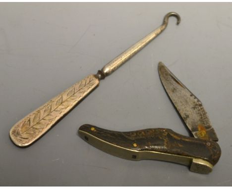 A horn penknife formed as a shoe; a silver handled button hook.