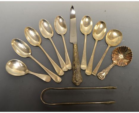 A pair of George III silver bright cut sugar bows, London 1803; a set of six Victorian silver rat tail pattern tea spoons, Bi