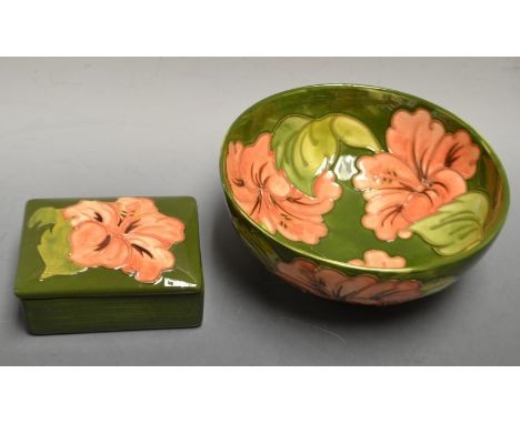 A Moorcroft Hibiscus pattern bowl, salmon flowers on a green ground, 15.5cm diameter; a similar trinket pot and cover, both w
