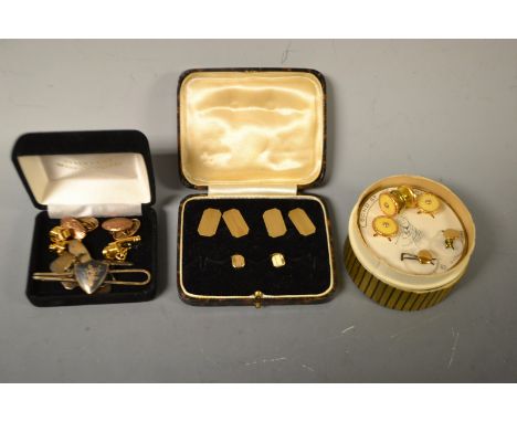 A pair of 9ct gold engine turned cuff links, collar studs en suite, 7g; a pair of Siam silver cuff links and similar tie clip