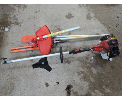 A Petrol strimmer with hedge trimmer, chainsaw attachments 