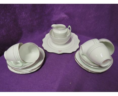 A part tea service un marked with green enamel trim