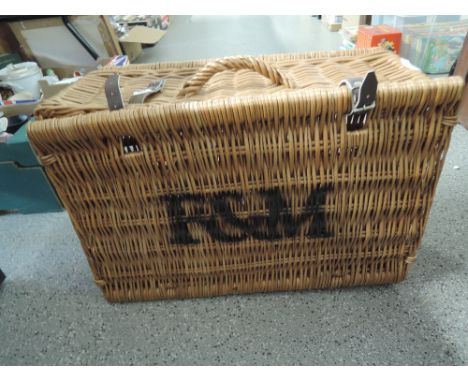 A vintage wicker woven picnic hamper