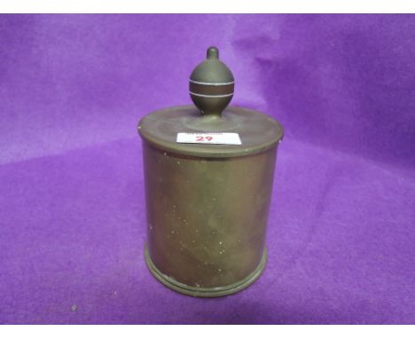 A vintage military ammunition shell worked into trench art tea caddy jar