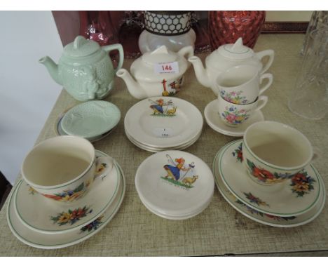 A selection of miniature dolls and child tea party cups saucers and tea pots