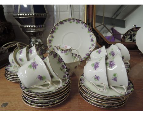 A vintage tea service by Royal Doulton with hand decorated enamel detailing