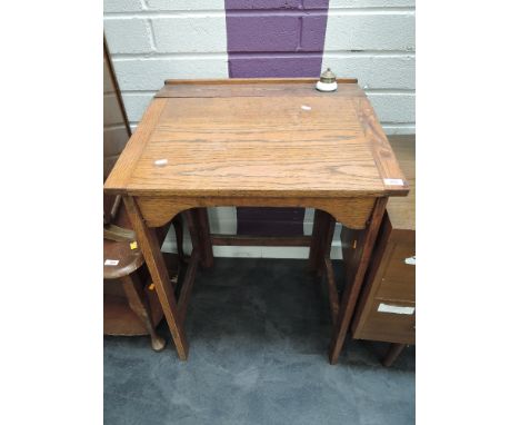 A vintage oak school desk having folding frame