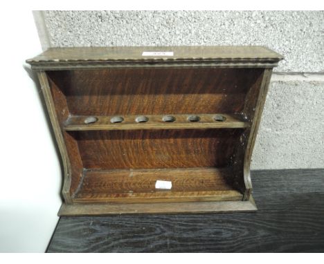 A vintage smokers pipe rack 