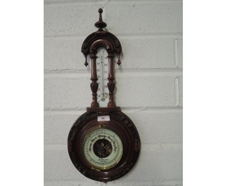 A vintage Barometer with treen body and enamel face by J T Smith Kendal