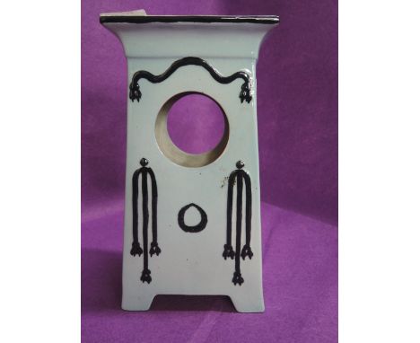 A vintage ceramic clock body in an Arts and Crafts style with blue and black glaze