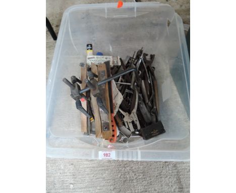 A box of various tools including leather punch, clamps spanners etc