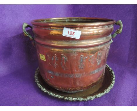 A vintage copper brass handle bucket