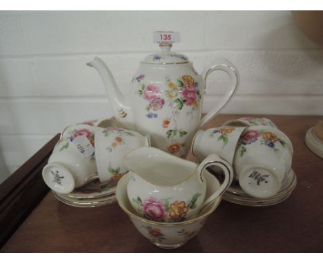 A part tea service with tea cups and saucers etc
