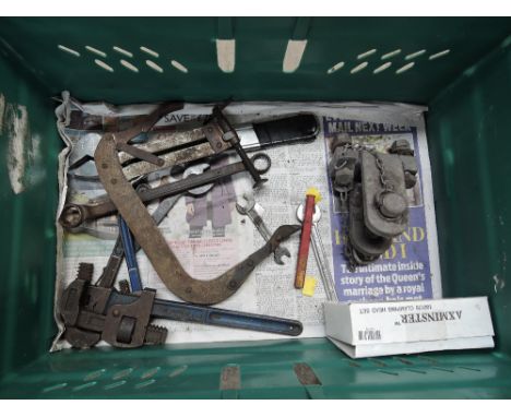 A box of various tools including a towing hitch, camps etc