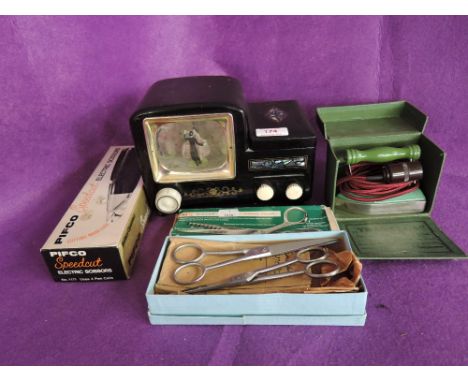A vintage music jewellery box modelled as tv set with pearly style inlay