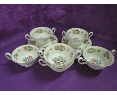 A selection of Wedgwood twin handle cups and saucers