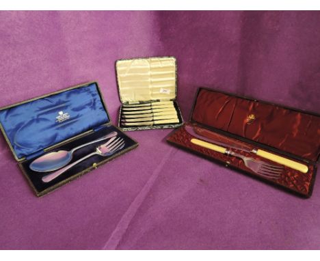 A selection of vintage flatware serving items and cutlery