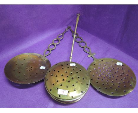 A selection of vintage brass chestnut and similar roasters 